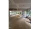 An open floor plan allows ample light into a spacious living room featuring multiple windows and a glass sliding door at 3302 Hall Pl, Raleigh, NC 27607