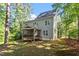 The house’s backyard has a screened-in porch, grass, and many surrounding trees at 4324 Brighton Ridge Dr, Apex, NC 27539