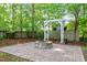 Landscaped backyard featuring a stone fire pit, and a decorative pergola at 4324 Brighton Ridge Dr, Apex, NC 27539