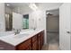 This bathroom features a double sink vanity, a shower and an open doorway into an adjacent bedroom at 4324 Brighton Ridge Dr, Apex, NC 27539