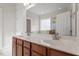 Bathroom with double vanity, framed mirror, and window offering ample natural light at 4324 Brighton Ridge Dr, Apex, NC 27539