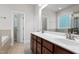 This bathroom boasts a double sink vanity with granite counters, tile floor and neutral fixtures at 4324 Brighton Ridge Dr, Apex, NC 27539
