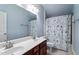 This bathroom features a double sink vanity, a shower/tub combo and a nautically themed shower curtain at 4324 Brighton Ridge Dr, Apex, NC 27539
