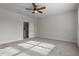 Bright bedroom features neutral walls, carpet, a ceiling fan, and a large window with natural light at 4324 Brighton Ridge Dr, Apex, NC 27539