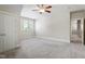 This large bedroom has soft carpet, a ceiling fan and large windows to let the sunshine in at 4324 Brighton Ridge Dr, Apex, NC 27539