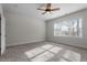 Bright bedroom features neutral walls, carpet, a ceiling fan, and a large window with natural light at 4324 Brighton Ridge Dr, Apex, NC 27539