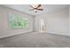 This bedroom is brightly lit with a carpeted floor and a beautiful outdoor view from the large window at 4324 Brighton Ridge Dr, Apex, NC 27539