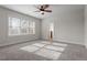 Spacious bedroom with neutral walls, carpet, and natural light offers a blank canvas for personalized decor at 4324 Brighton Ridge Dr, Apex, NC 27539