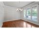 Elegant dining room with hardwood floors, large windows, and chandelier at 4324 Brighton Ridge Dr, Apex, NC 27539