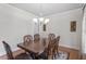 Elegant dining room with a traditional wooden table, patterned rug, and chandelier at 4324 Brighton Ridge Dr, Apex, NC 27539