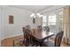 Traditional dining room featuring hardwood floors, large window, and an elegant chandelier at 4324 Brighton Ridge Dr, Apex, NC 27539