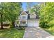 Charming two-story home featuring a welcoming front porch, two-car garage, and lush landscaping at 4324 Brighton Ridge Dr, Apex, NC 27539