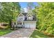Charming two-story home featuring a welcoming front porch, two-car garage, and lush landscaping at 4324 Brighton Ridge Dr, Apex, NC 27539