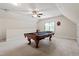 A large game room featuring a pool table, ceiling fan, and natural light at 4324 Brighton Ridge Dr, Apex, NC 27539