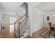 Hallway with staircase and views into the living and dining areas at 4324 Brighton Ridge Dr, Apex, NC 27539
