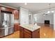 Kitchen and living area features wooden cabinets, stainless steel appliances, and a fireplace at 4324 Brighton Ridge Dr, Apex, NC 27539