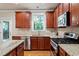 Well-equipped kitchen featuring wooden cabinetry, granite countertops, and stainless steel appliances at 4324 Brighton Ridge Dr, Apex, NC 27539