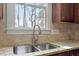 Close-up of a stainless steel sink in a kitchen with granite countertops at 4324 Brighton Ridge Dr, Apex, NC 27539