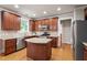 Spacious kitchen showcases wooden cabinetry, stainless steel appliances, granite countertops, and an island at 4324 Brighton Ridge Dr, Apex, NC 27539
