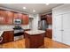 Bright kitchen featuring wooden cabinets, stainless steel appliances, and an island with granite countertop at 4324 Brighton Ridge Dr, Apex, NC 27539