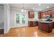 Open kitchen area featuring wooden cabinetry, stainless steel appliances, an island, and door leading to an outdoor porch at 4324 Brighton Ridge Dr, Apex, NC 27539