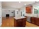 Open kitchen boasts wooden cabinets, stainless steel appliances, granite counters, and views to the living area at 4324 Brighton Ridge Dr, Apex, NC 27539