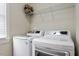Efficient laundry room featuring modern washer and dryer units, plus overhead storage at 4324 Brighton Ridge Dr, Apex, NC 27539