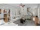 Open-concept living room with hardwood floors, staircase, and seamless flow to the kitchen at 4324 Brighton Ridge Dr, Apex, NC 27539