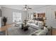 Inviting living room with hardwood floors and an open view of the modern, eat-in kitchen at 4324 Brighton Ridge Dr, Apex, NC 27539