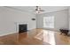 Bright living room featuring a fireplace and gleaming hardwood floors at 4324 Brighton Ridge Dr, Apex, NC 27539