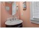Elegant powder room with a decorative sink, round mirror, and soft lighting at 4324 Brighton Ridge Dr, Apex, NC 27539