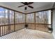 Relaxing screened porch with wood flooring, ceiling fan, and peaceful views of the surrounding trees at 4324 Brighton Ridge Dr, Apex, NC 27539