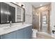 Modern bathroom with double sinks, sleek cabinets, and a glass-enclosed shower at 512 Gordon Street # 602, Durham, NC 27701