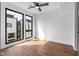 Bedroom featuring hardwood floors, large windows, and a ceiling fan for comfort at 512 Gordon Street # 602, Durham, NC 27701
