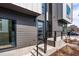 Contemporary home featuring a modern glass front door, stylish gray siding and neat, minimalist landscaping at 512 Gordon Street # 602, Durham, NC 27701
