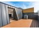 Modern roof deck features an air conditioning unit and nice wood flooring under a bright sky at 512 Gordon Street # 602, Durham, NC 27701