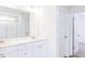Bathroom featuring double sinks with white quartz countertops, shower, and modern fixtures at 59 Davinhall Dr, Fuquay Varina, NC 27526