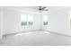 Large bedroom with two windows offering exterior views and a ceiling fan at 59 Davinhall Dr, Fuquay Varina, NC 27526