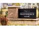 Community sign of Providence Creek set amidst natural landscaping and greenery at 59 Davinhall Dr, Fuquay Varina, NC 27526
