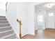 Bright entryway features wood-look flooring and a carpeted staircase at 59 Davinhall Dr, Fuquay Varina, NC 27526