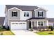 Charming two-story home featuring a two-car garage, stone accents, and a welcoming front porch at 59 Davinhall Dr, Fuquay Varina, NC 27526