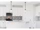 Kitchen with white cabinets, quartz countertops, and stainless steel appliances at 59 Davinhall Dr, Fuquay Varina, NC 27526