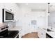 Modern kitchen featuring stainless steel appliances, sleek cabinets, and a subway tile backsplash at 59 Davinhall Dr, Fuquay Varina, NC 27526