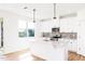 Kitchen with white cabinets and countertops and stainless steel appliances at 59 Davinhall Dr, Fuquay Varina, NC 27526