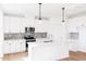 Kitchen with white cabinets, quartz countertops and stainless steel appliances at 59 Davinhall Dr, Fuquay Varina, NC 27526