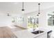 Spacious and bright open concept living room with modern light fixtures and hardwood floors at 59 Davinhall Dr, Fuquay Varina, NC 27526