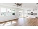 Open concept living room boasts hardwood floors, bright windows, and flows into the modern kitchen at 59 Davinhall Dr, Fuquay Varina, NC 27526
