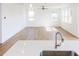 Open concept living room with modern light fixtures and hardwood floors; an ideal space for families at 59 Davinhall Dr, Fuquay Varina, NC 27526