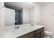 Well-lit bathroom with double vanity, modern fixtures, and a glass-enclosed shower at 728 Silo Park Dr, Wake Forest, NC 27587