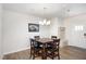 Dining room with a wooden table, four chairs, modern lighting, and neutral-toned walls at 728 Silo Park Dr, Wake Forest, NC 27587